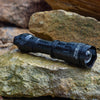 Nightfox XB5 Pro INFRARED LED TORCH - 940nm | Placed on a rock | Wet
